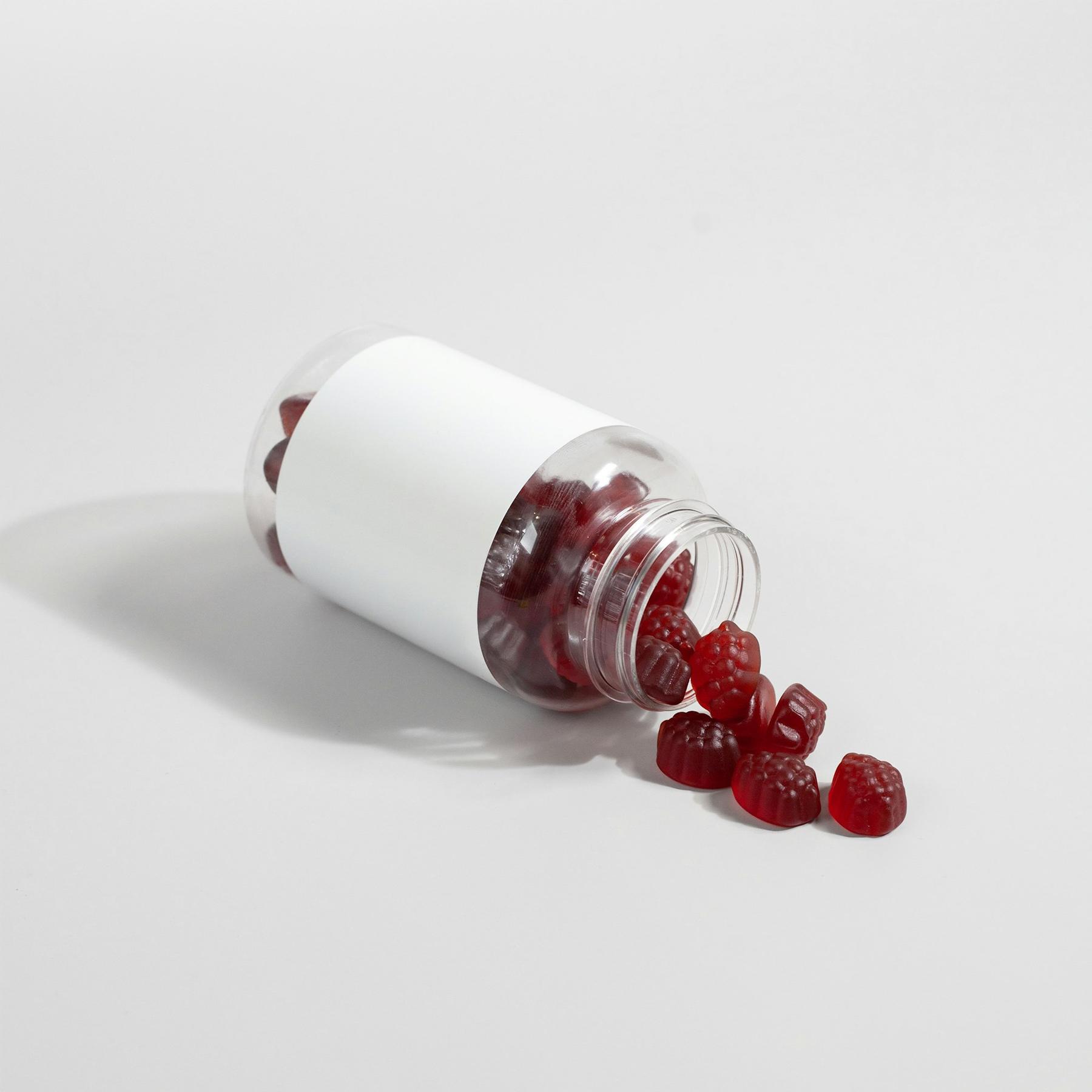 Supplement bottle with red gummies