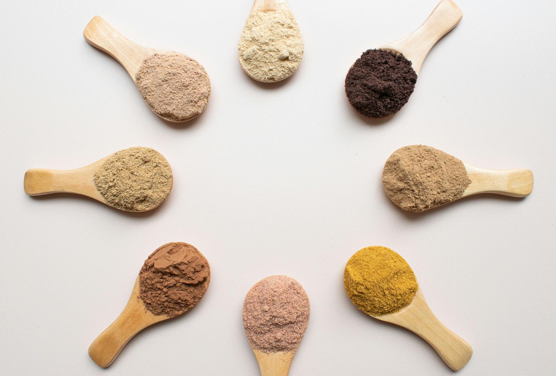 Wooden spoons holding different powders